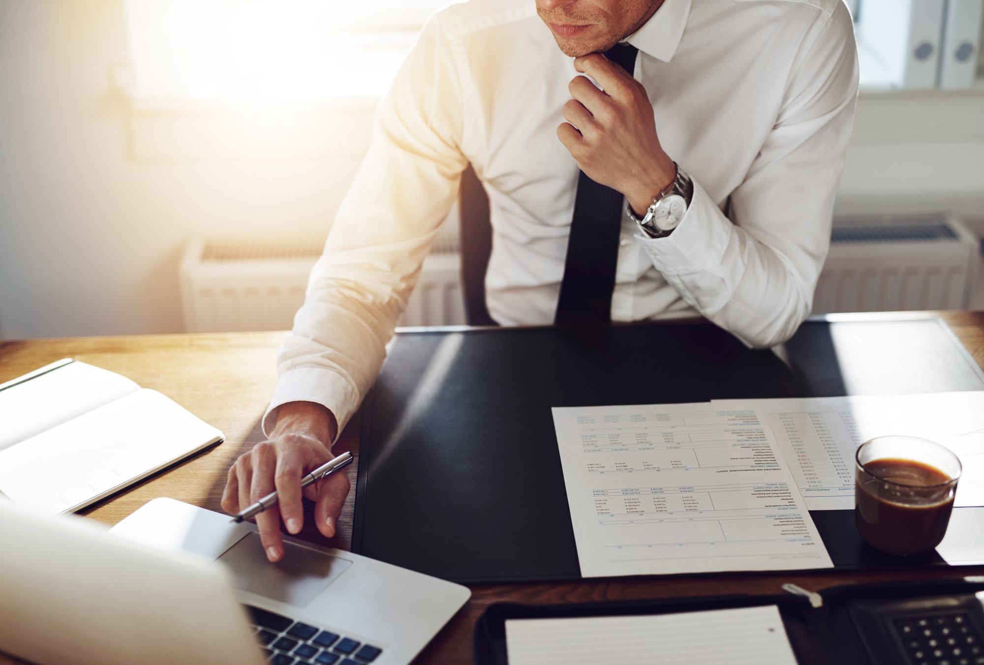Business man working at office with laptop and documents